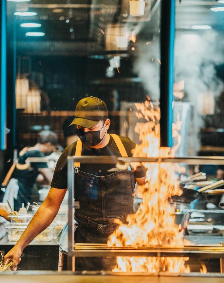 Lux* Grand Baie Resort & Residences Esterno foto A chef cooking with a blowtorch